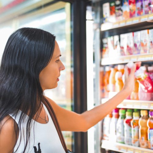 Woman buying juice in the store