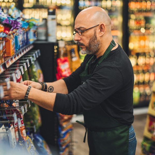 A small business owner at work in his small convenience store.